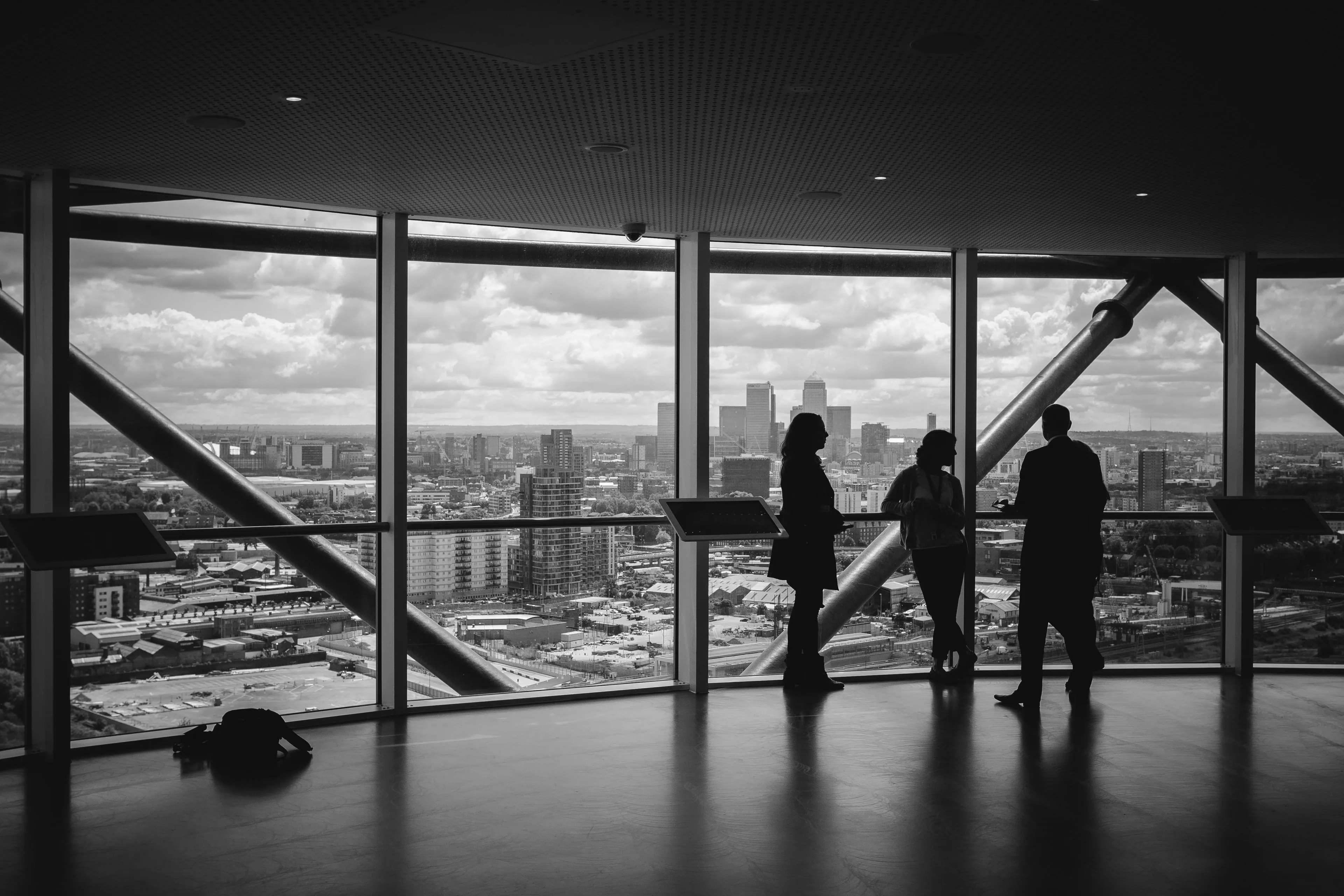 Advisors reviewing work together in an office overlooking a city